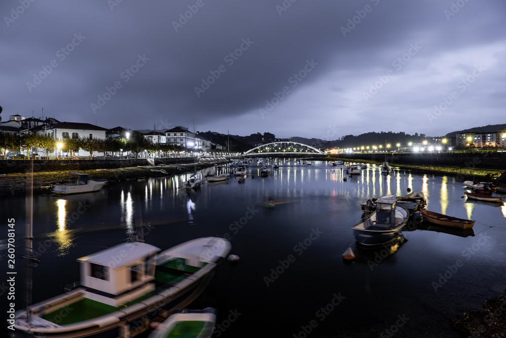 Long exposure of boats in tidal at night