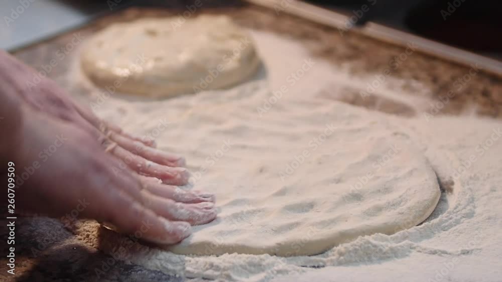 Chef cook pizza man preparing an organic delicious pizza kneading a soft dough and shaping it as a circle. Slow motion. Chef cook pizza man preparing an organic delicious pizza kneading a soft dough and shaping it as a circle. Slow motion.