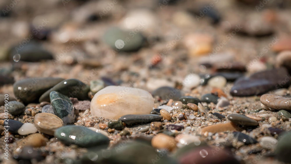 shimmering wet stones and pebbles on the beach