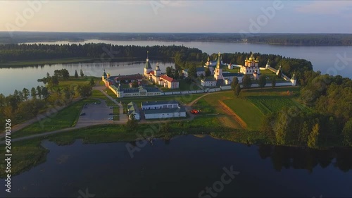 Top view from drone to Valdai Iversky Svyatoozersky Virgin Monastery for Men. Selvitsky Island, Valdai Lake. Bird's-eye view on summer evening photo