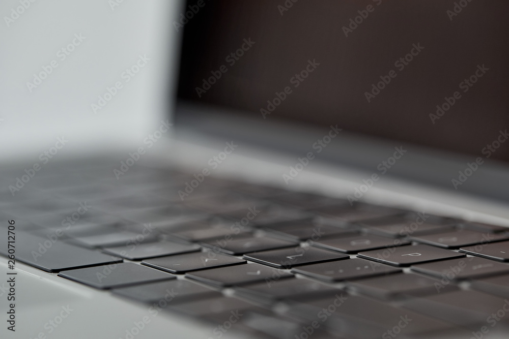 selective focus of laptop with blank screen and black keyboard