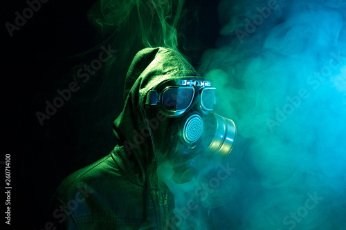 Military gas mask for protection. Fireman inside the smoke.Terrorism,war and pollution concept.Dramatic