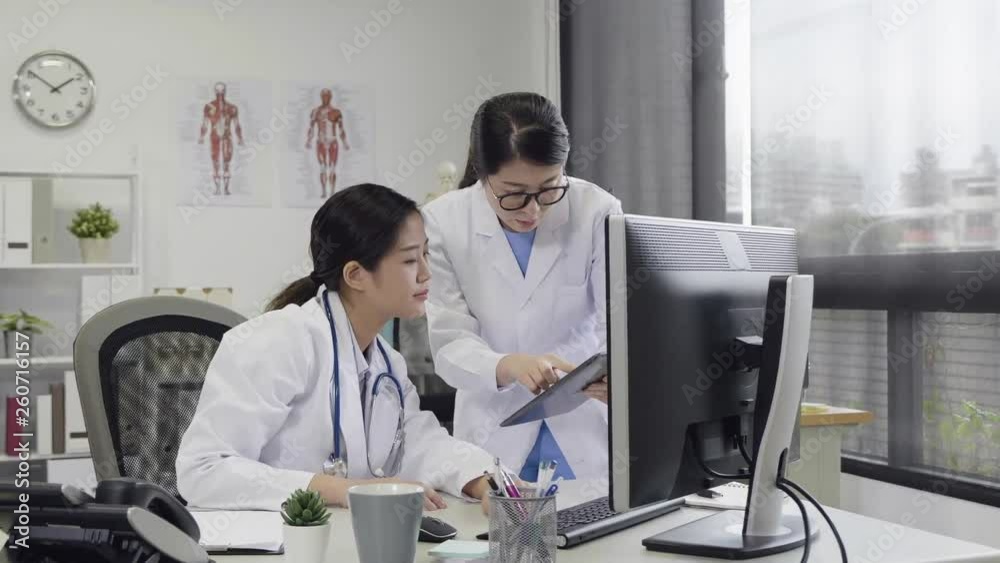 hospital working office female doctor walking close to coworker to ask question solve problem have discussion while using tablet computer. modern place medical team staff consider situation patient hospital working office female doctor walking close to coworker to ask question solve problem have discussion while using tablet computer. modern place medical team staff consider situation patient