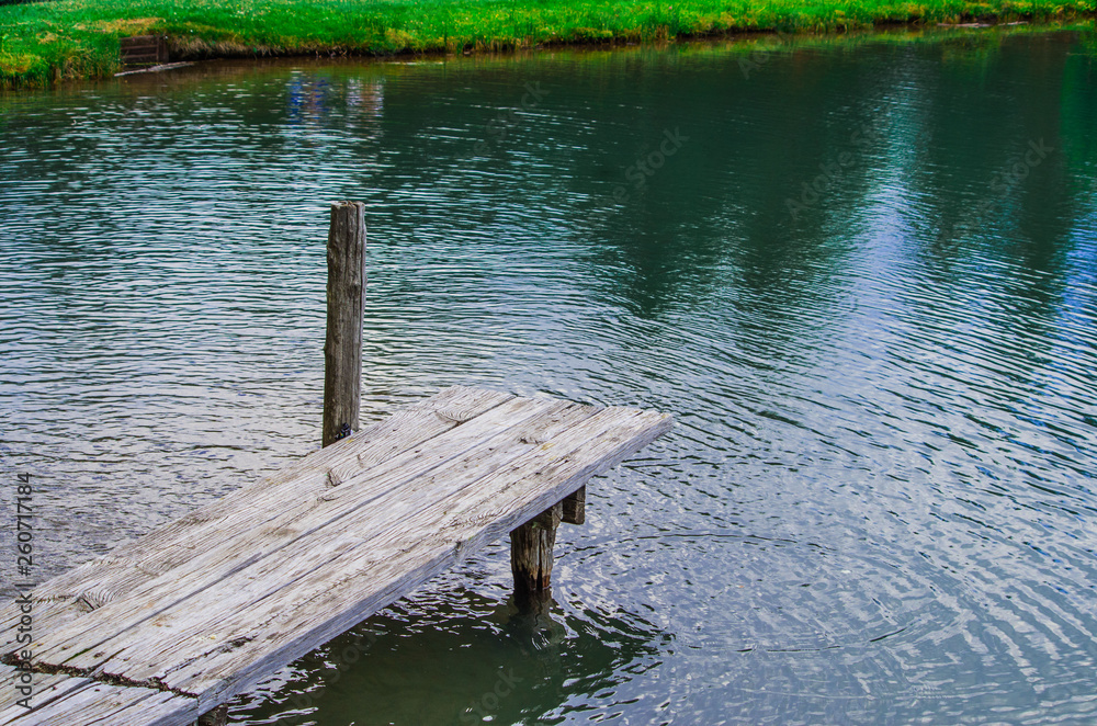 old wooden pier on the lake with fresh and clean spring water