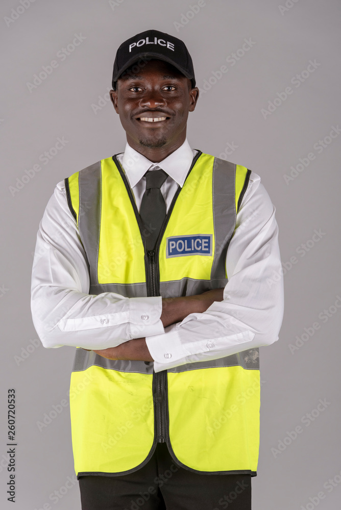 Salisbury, Wiltshire, UK. April 2019. Portrait of a smiling police officer in uniform with arms folded