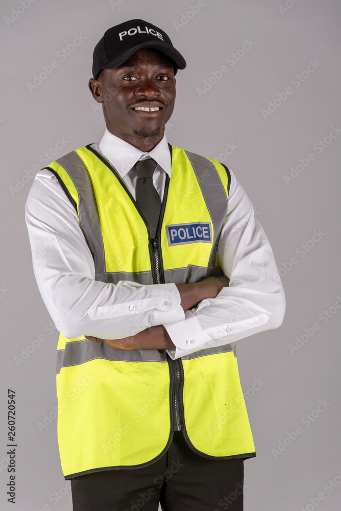 Salisbury, Wiltshire, UK. April 2019. Portrait of a smiling police officer in uniform with arms folded Salisbury, Wiltshire, UK. April 2019. Portrait of a smiling police officer in uniform with arms folded