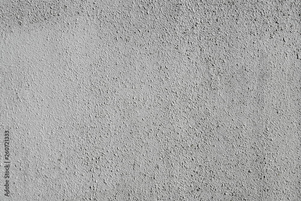 Fototapeta premium Plain gray textured plastered wall. Rough textured background of wall with copy space for text