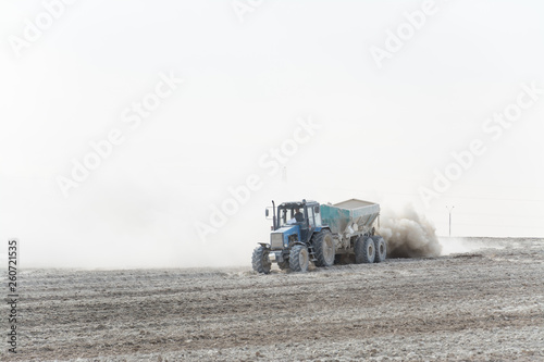 Tractor fertilizes agricultural fields