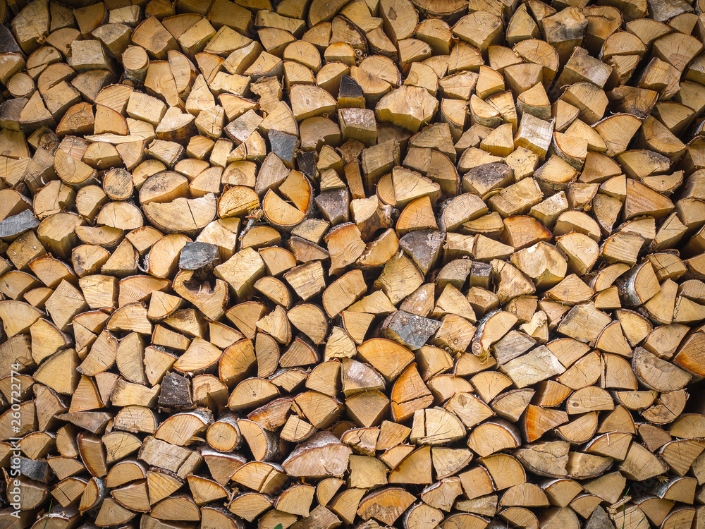 A stack of firewood - wooden abstract horizontal background A stack of firewood - wooden abstract horizontal background