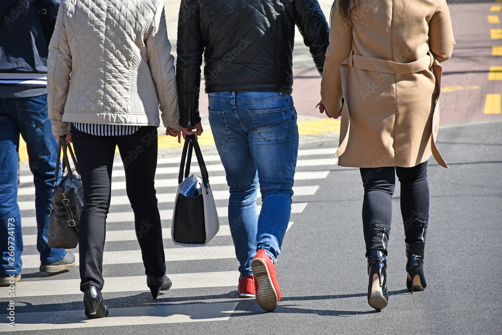 People are walking at the pedestrian crossing People are walking at the pedestrian crossing