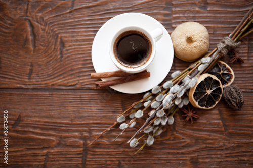 Coffee cup and willow branches, dry lemon, cinnamon.