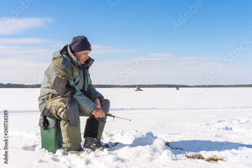 fisherman fishing winter fishing on a bright Sunny day