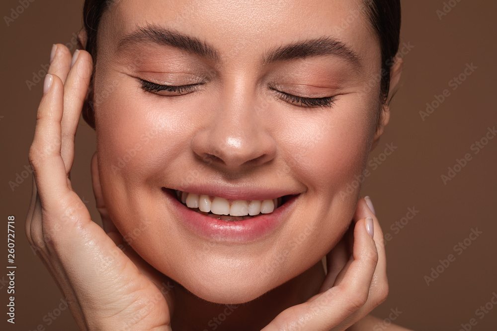Excited woman standing with closed eyes and smiling Excited woman standing with closed eyes and smiling