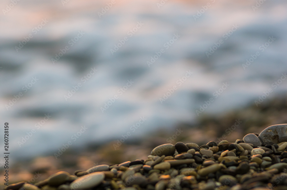 pebble stones on the sea beach, the rolling waves of the sea with foam pebble stones on the sea beach, the rolling waves of the sea with foam