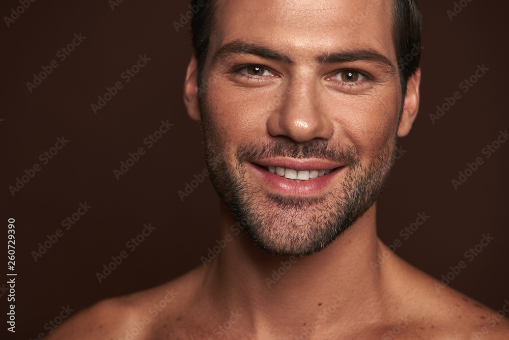 Portrait of happy attractive man isolated on brown Portrait of happy attractive man isolated on brown