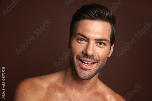 Close up happy smiling muscular male model