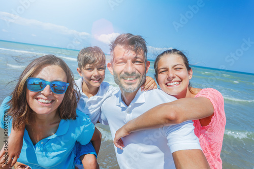 Happy family having fun at beach together. Fun happy lifestyle in the summer leisure