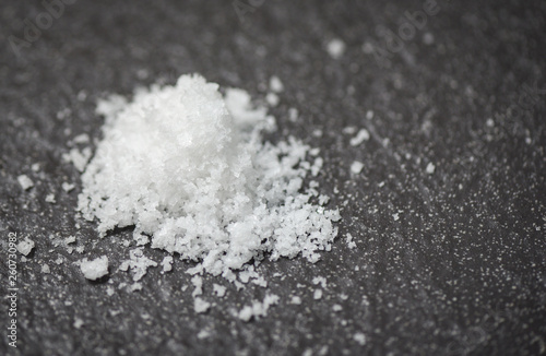 Heap of white salt on dark background © Bigc Studio