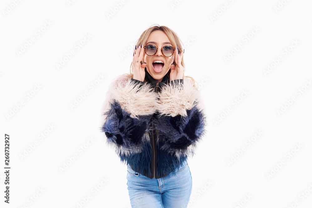 Fashion Model girl portrait isolated on white background. Beauty stylish brunette woman posing in fashionable clothes, fur coat, sunglasses, denim in studio. Casual style. High fashion urban style Fashion Model girl portrait isolated on white background. Beauty stylish brunette woman posing in fashionable clothes, fur coat, sunglasses, denim in studio. Casual style. High fashion urban style