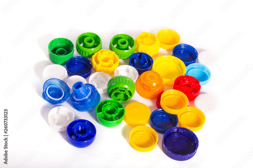 Plastic pollution. Some plastic caps isolated on white background Plastic pollution. Some plastic caps isolated on white background