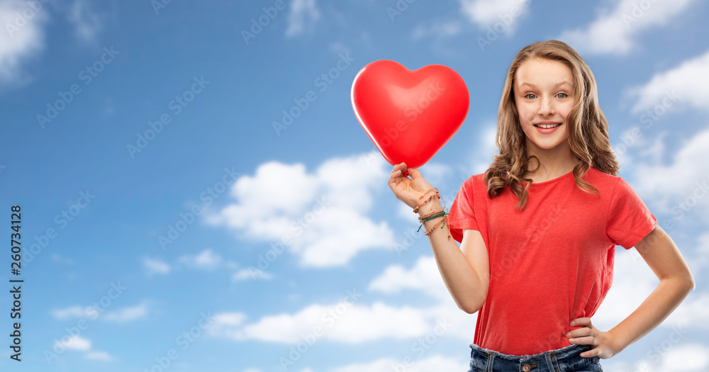 valentine's day, love and people concept - smiling pretty teenage girl with long hair in red t-shirt holding heart shaped balloon over blue sky and clouds background valentine's day, love and people concept - smiling pretty teenage girl with long hair in red t-shirt holding heart shaped balloon over blue sky and clouds background