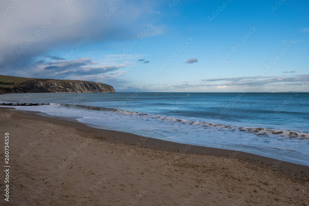 Groins and sea surf on a pebble beach