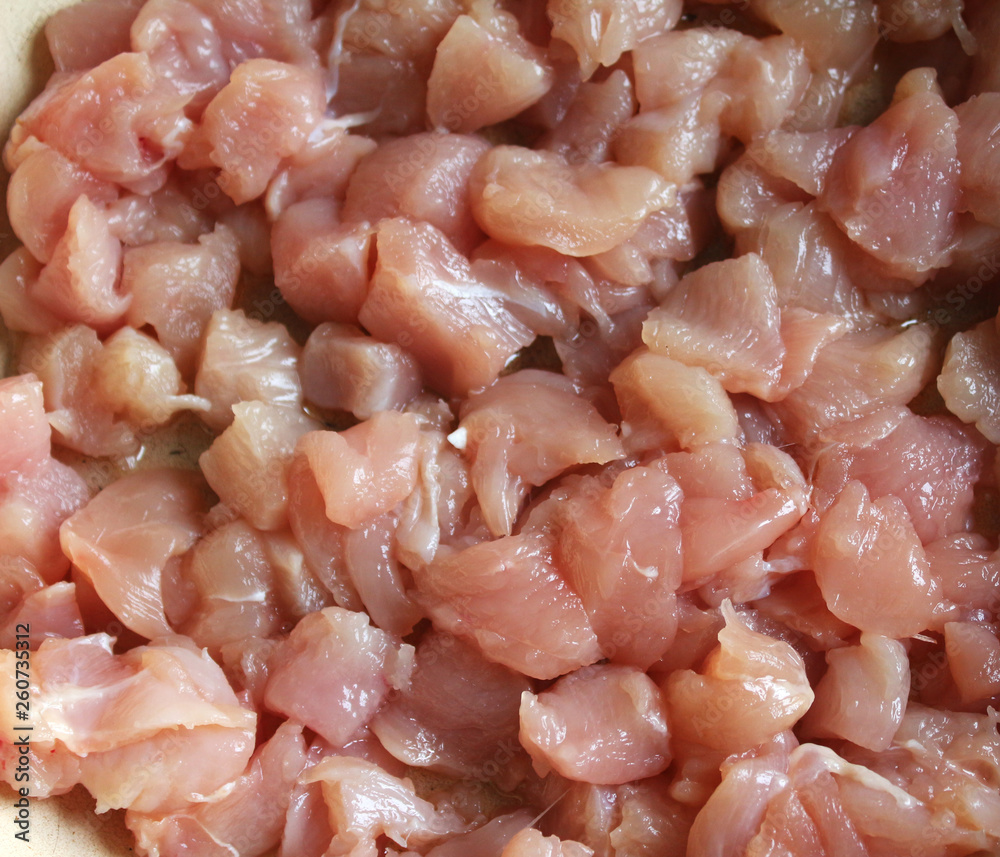 Diced chicken. Pattern raw meat. Fresh raw chicken breast to diced. ingredient and staple food, top view. Diced chicken. Pattern raw meat. Fresh raw chicken breast to diced. ingredient and staple food, top view.