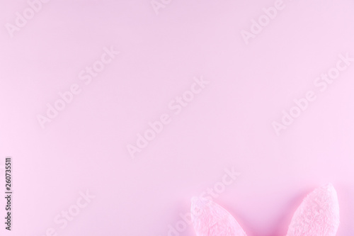 Fluffy Easter bunny ears as symbol of Christian religious holiday. Copy space, close up, flat lay, top view, bright colorful background. © Evrymmnt