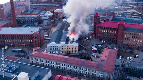 Firefighters extinguish a burning building  aerial view