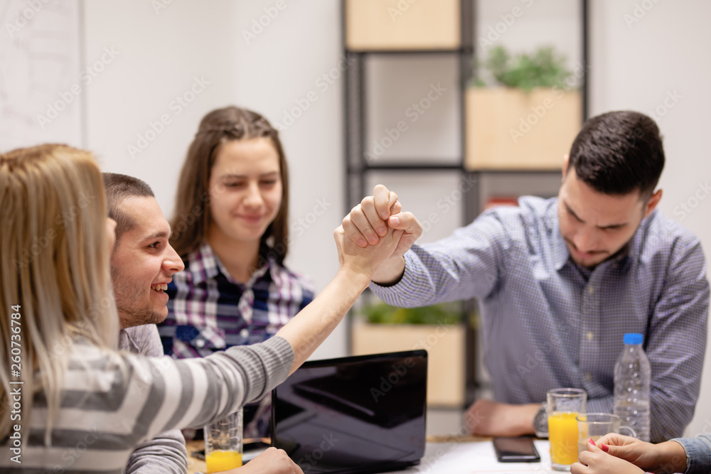 group of young creatives, shaking hands group of young creatives, shaking hands