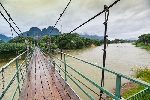 Wooden suspension bridge crossing the river Vang Vieng Laos