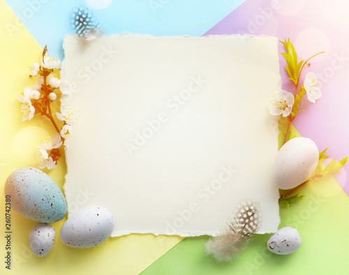 Easter background; Easter Eggs with spring Flowers on colorful Background