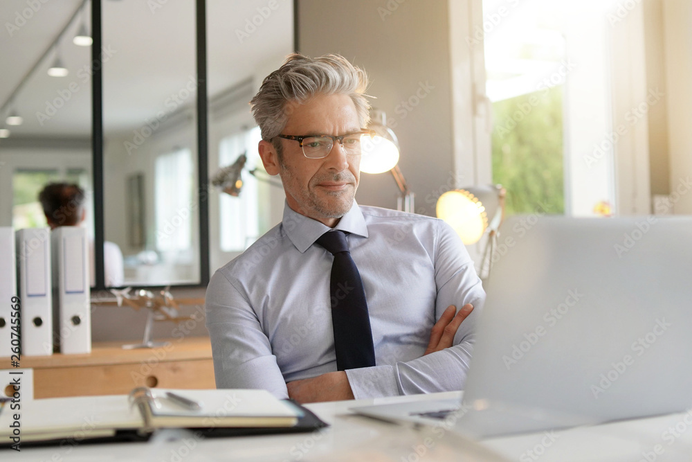 © goodluz - Handsome businessman working in contemporary office © goodluz - Handsome businessman working in contemporary office