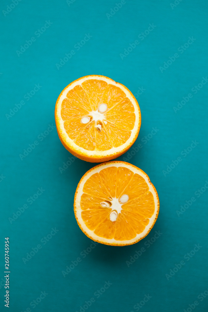 Cut oranges (halfs of orange) on the turquois background Cut oranges (halfs of orange) on the turquois background