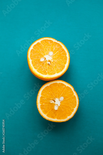 Cut oranges  halfs of orange  on the turquois background