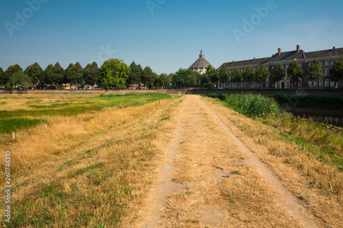 Church Sint Cathrienkerk, buildings, city wall, path in nature park Bossche Broek in Den Bosch, 's Hertogenbosch, The Netherlands photo