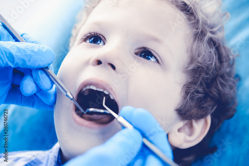 Doctor and patient child. Boy having his teeth examined with dentist. Medicine, health care and stomatology concept