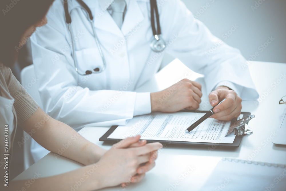 Doctor man and patient are discussing something, just hands at the table. Medicine and health care concepts Doctor man and patient are discussing something, just hands at the table. Medicine and health care concepts
