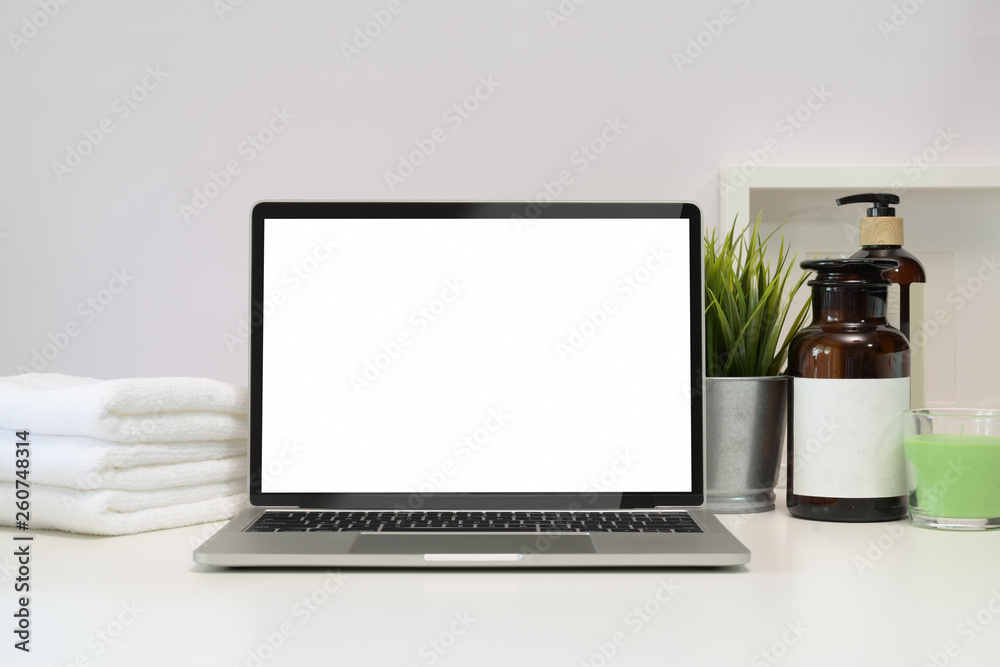Fototapeta premium Blank screen laptop on spa table