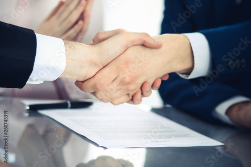 Business people shaking hands finishing up a meeting. Handshake at successful negotiation