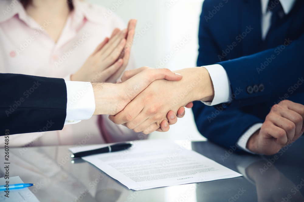 Business people shaking hands finishing up a meeting. Handshake at successful negotiation Business people shaking hands finishing up a meeting. Handshake at successful negotiation