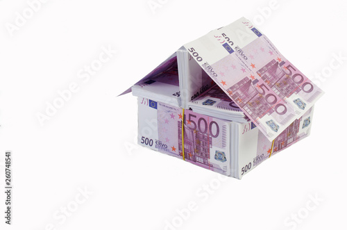A house made of banknotes, 500 euro bills. Housing construction symbol. Isolated on white.