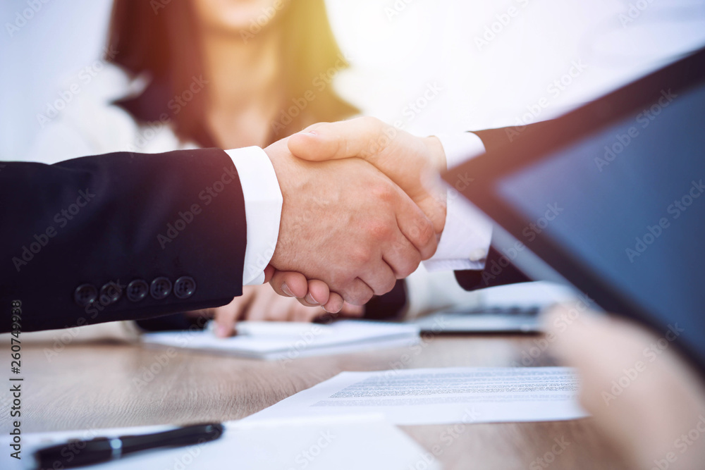 Business people shaking hands at meeting or negotiation in the office. Handshake concept. Partners are satisfied because signing contract Business people shaking hands at meeting or negotiation in the office. Handshake concept. Partners are satisfied because signing contract