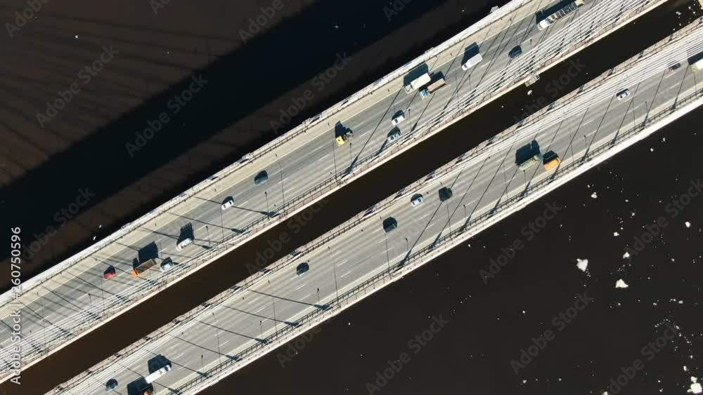 Cars driving on a modern cable-stayed bridge, aerial view vertically down. Cars driving on a modern cable-stayed bridge, aerial view vertically down.