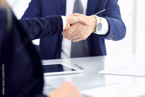 Group of business people or lawyers shaking hands finishing up a meeting , close-up. Success at negotiation and handshake concepts