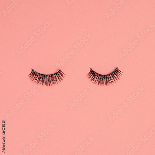 Eyelash extension, concept. Women's eyelashes on pink background,