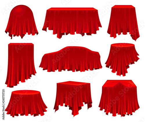 Collection of objects hidden under red cloth.
