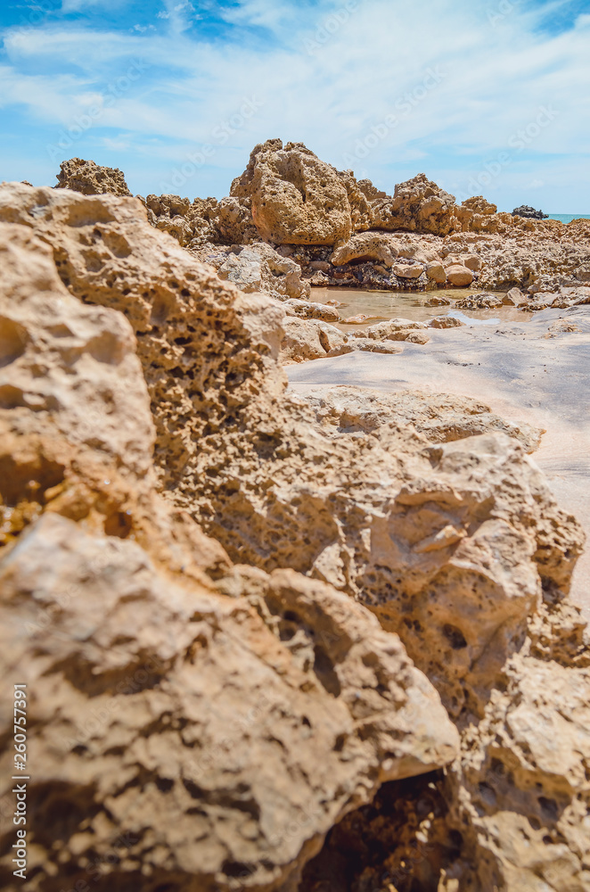 Beach rocks, rocks with holes made by the waves of the sea. Spongy rocks. Set of rocks near the sea at Praia de Coqueirinho beach, Brazilian northeast beach. Costa do Conde, Conde PB Brazil.