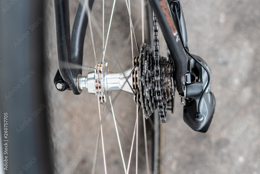Fototapeta premium Road bicycle rear wheel hub with multi speed cassette and chain with spokes and rim