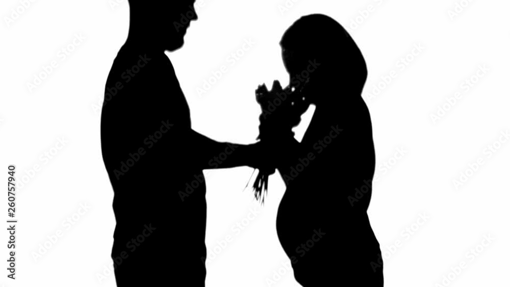 Side view of silhouette of man presenting flower bouquet to pregnant woman isolated on white Side view of silhouette of man presenting flower bouquet to pregnant woman isolated on white